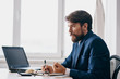© SHOTPRIME STUDIO - business man with a beard working on a laptop in the office