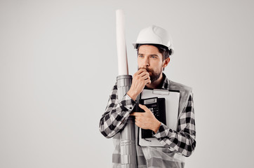 builder in a helmet with drawings documents architecture