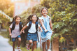 © pingpao - Back to school. Asian  pupil kids with backpack running and going to school together with fun and happiness in vintage color tone