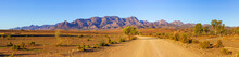 Gravel Countryside Road Leading To Rugged Peaks Of Flinders Ranges Mountains In South Australia
