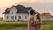 © Smole - rear view of young couple looking at their new house