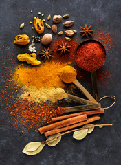 Wall Mural - Spices and seasonings in measuring spoons and on a table