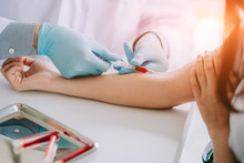 Close Up Hand Of Nurse, Doctor Or Medical Technologist In Blue Gloves Taking Blood Sample From A Patient In The Hospital.