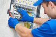 © Kadmy - Electrician assembling power switchboard