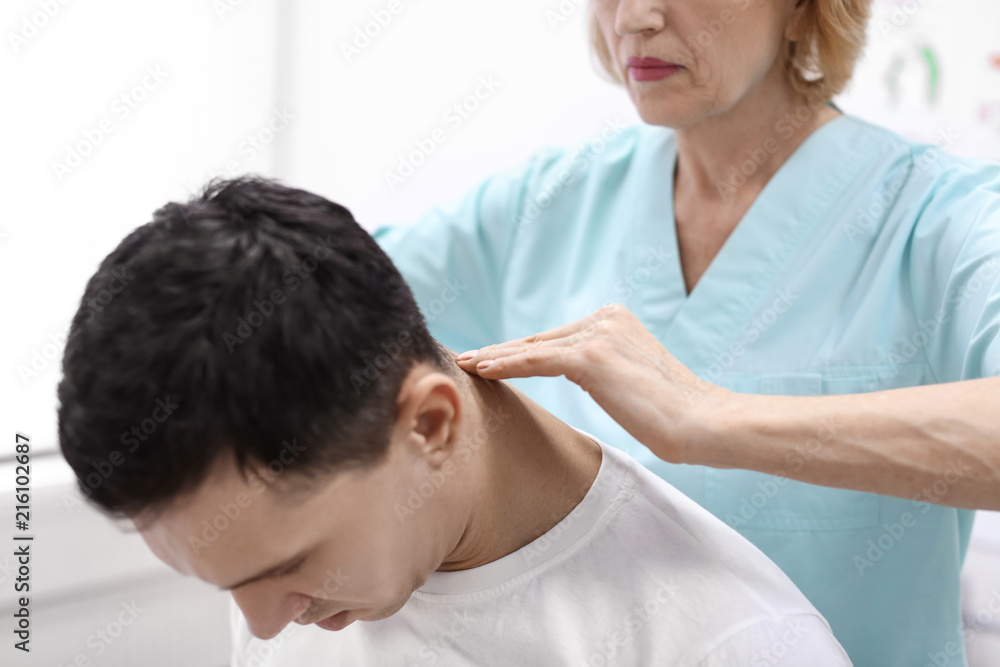 Orthopedist examining patient in hospital