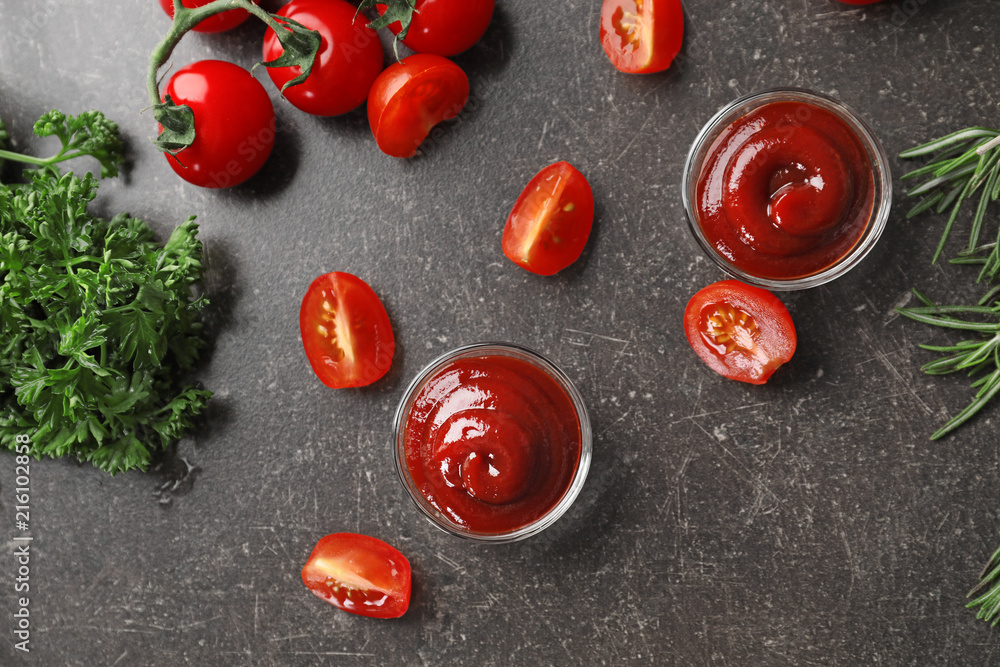 Composition with tasty tomato sauce on grey background