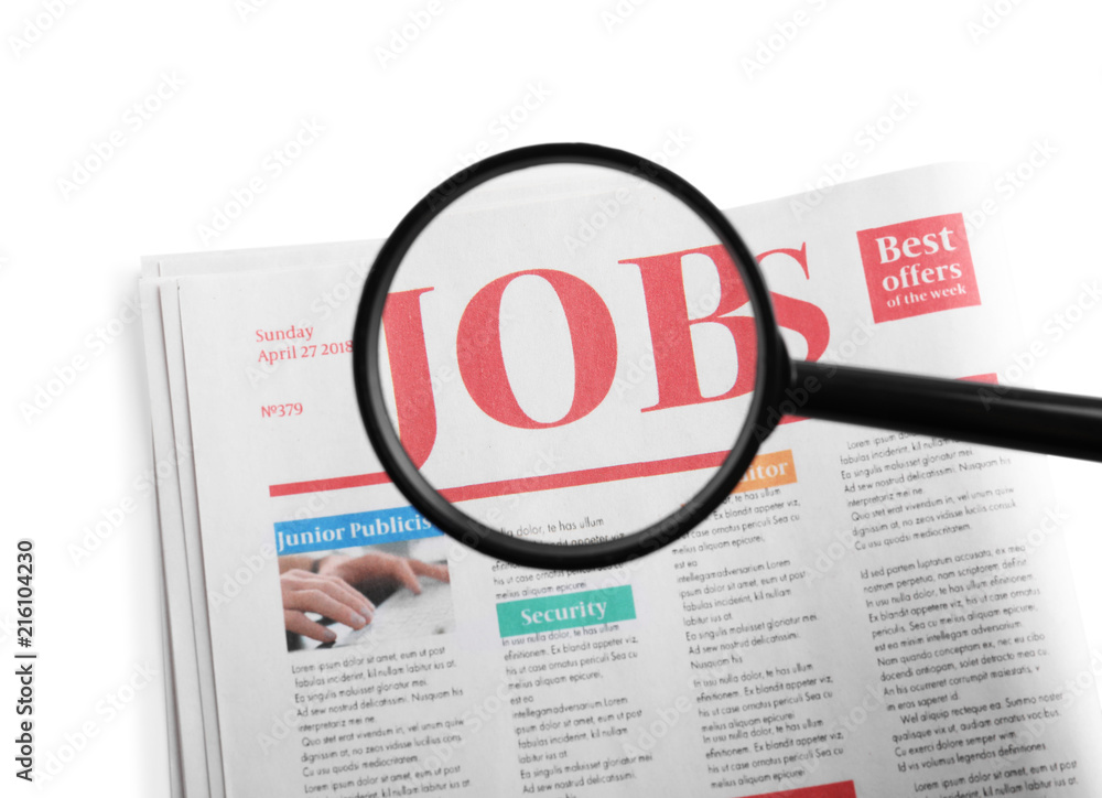 Magnifying glass and newspaper with headline JOBS on white background