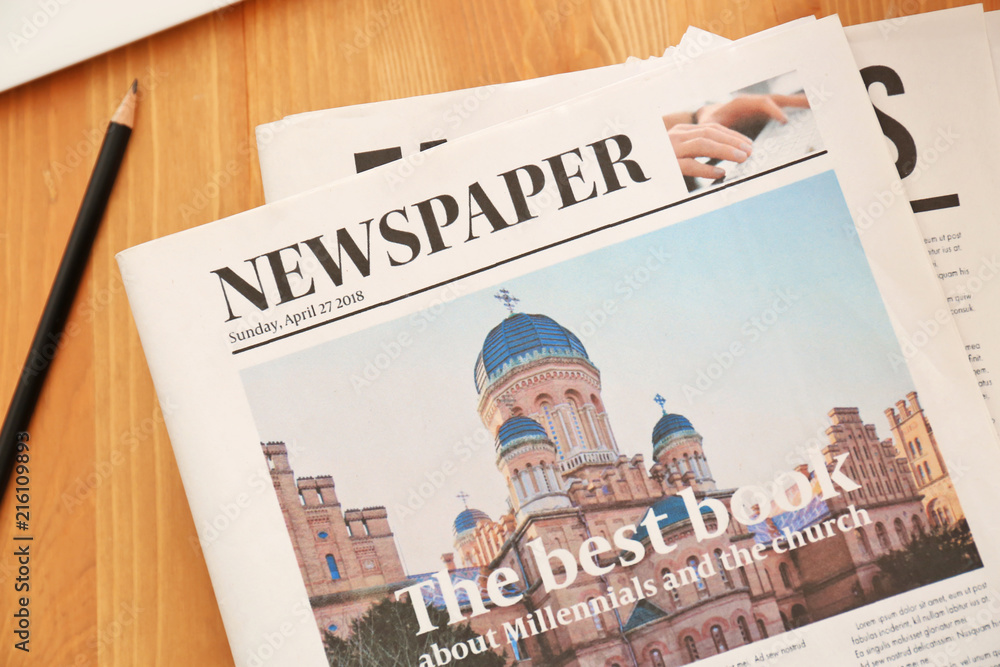 Newspapers on wooden table
