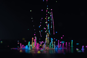 Abstract sculptures of colorful splashes of paint. Dancing liquid on a black background. Ink water splash. Color explosion.