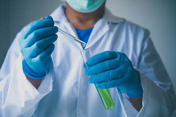 Wall Mural - Equipment and science experiments oil pouring scientist with test tube green making research in laboratory.