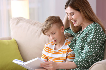 Sticker - Mother and her son reading book together at home