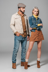 Poster - fashionable couple posing in street style autumn outfit, on grey