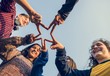 © Rawpixel.com - Group of friends using fingers to form the star shape teamwork and support concept