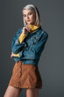 © LIGHTFIELD STUDIOS - fashionable model posing in turtleneck, trendy corduroy skirt and jeans jacket, isolated on grey