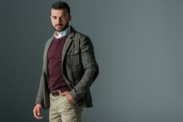 Wall Mural - handsome bearded man posing in autumn tweed jacket, isolated on grey