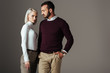 © LIGHTFIELD STUDIOS - stylish couple posing in elegant autumn outfit, isolated on grey