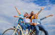 © be free - Freedom urban commuting. Bicycle as part of life. Cycling modernity and national culture. Group friends hang out with bicycle. Company stylish young people spend leisure outdoors sky background