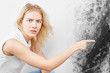 Wall fungus. Aspergillus. A beautiful girl in a white T-shirt points a finger at the black mold on the wall..