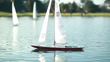 Remote Controlled Yacht Being Raced On A Pond, Slow Motion