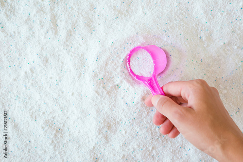 Woman S Hand Holding A Pink Cup Or Scoop Of White Powder