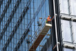 Construction workers on a suspended platform on a skyscraper