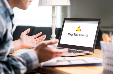 Page not found and error in laptop. Bad or slow internet connection. Frustrated man spreading hands in home office desk. Broken computer not working. Online information problem. Alert icon in website.