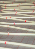 Fototapeta  - Flexible PVC tubing for high-pressure heated floor systems, custom installed in its' finished layout
