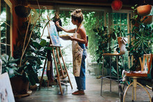 Woman Drawing On A Camvas In Art Studio