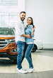 © My Ocean studio - Happy young couple chooses and buying a new car for the family.