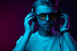 © monchak - Neon portrait of bearded man in headphones, sunglasses, white t-shirt. Listening to music