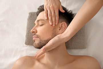 Wall Mural - Handsome man having facial massage in spa salon