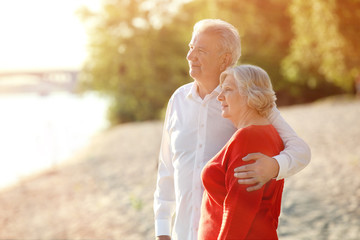 Happy mature couple on riverside