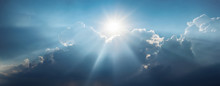 Panoramic View Of Clouds And Sun With Beautiful Rays Against The Sky.