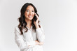 © Drobot Dean - Image closeup of attractive chinese woman with long dark hair holding smartphone and having mobile call, isolated over white background in studio
