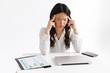 © Drobot Dean - Photo of overworked tired asian business woman 20s wearing office clothing sitting at table with laptop and grabbing head, isolated over white background