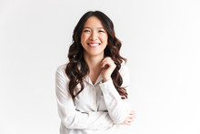 Portrait Of Gorgeous Asian Woman With Long Dark Hair Laughing At Camera With Beautiful Smile, Isolated Over White Background In Studio