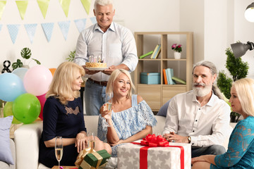 Wall Mural - Mature people at birthday party at home