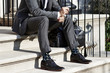 © Will Anderson - Man in suit sitting on stairs