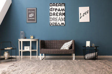 Wall Mural - Stylish interior of living room with comfortable sofa near color wall