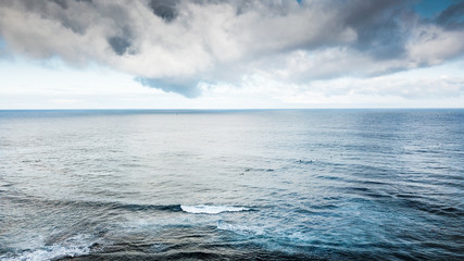 beautiful coloured blue aerial view of water and oceanic waves. great sky with clouds and beauty background. outdoor nature landscape for vacation and travel concept