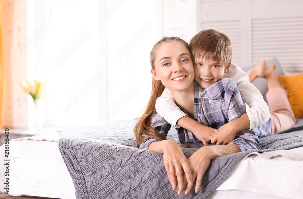 Happy mother with son resting at home