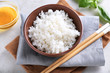 © Pixel-Shot - Bowl with boiled white rice on grey table