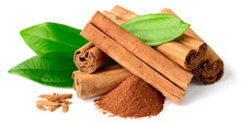 Cinnamon Powder And Sticks With Fresh Leaves Isolated On The White Background