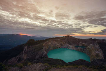 Wall Mural - View of Mount Kelimutu and beautiful milky way with Tiwu Ko'o Fai Nuwa Muri and Tiwu Ata Polo  from small town of Moni, Ende,   Flores Island, Indonesia.