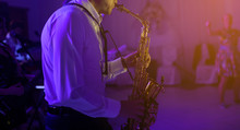 The Saxophonist Plaing At The Party