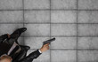 © serikbaib - bald criminal in a suit and with a gun