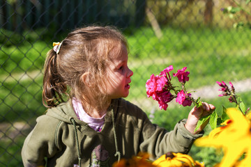 little and happy girl on flowers background