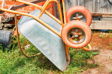 Old Rusty Wheelbarrow Cart In The Garden