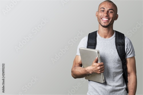 Fotomural Portrait of smiling young african college student