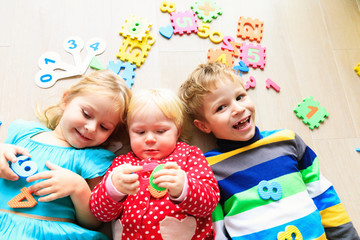 Wall Mural - happy little girls and boy learn numbers and shapes